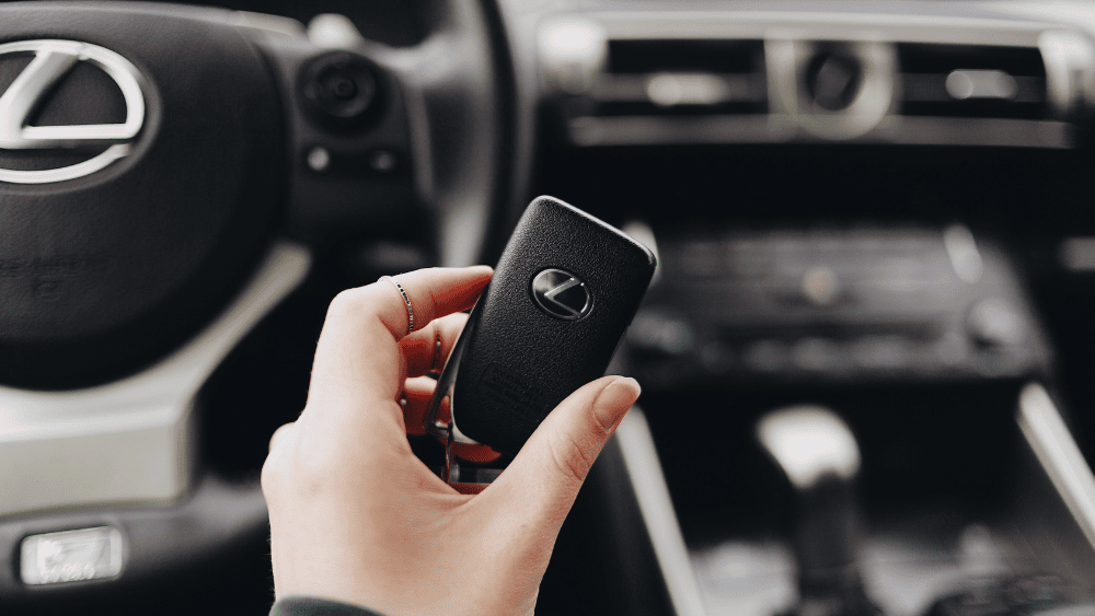 person holding car key for finance